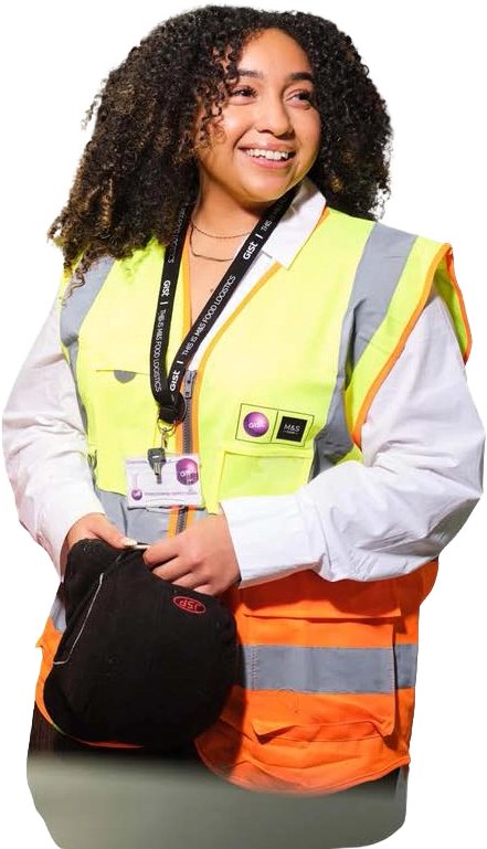 A smiling Gist apprentice in high-visibility workwear holding her helmet