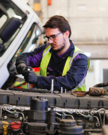 An apprentice working on an engine